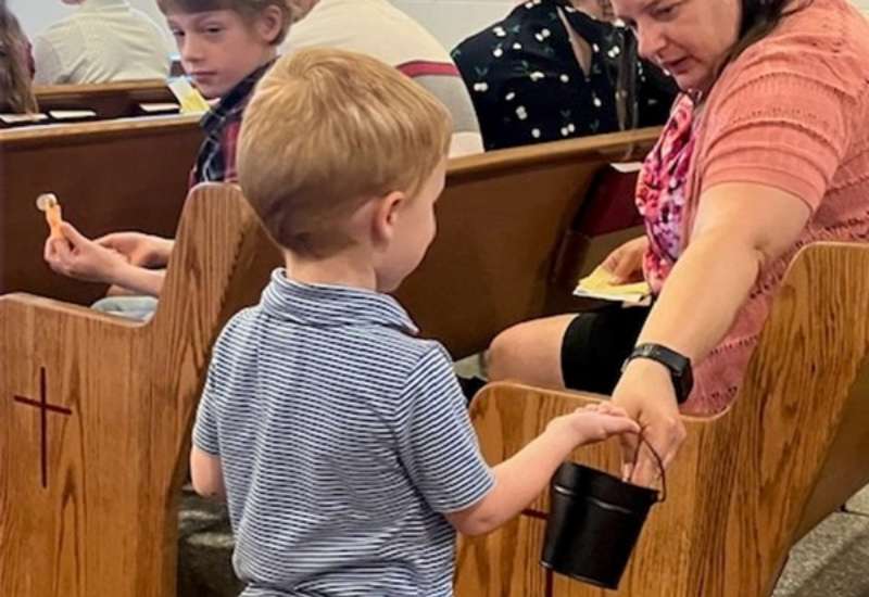 A child participates in church services