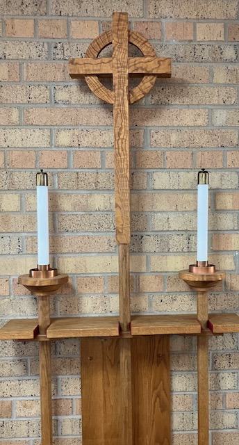 Christian cross with candles on either side. 